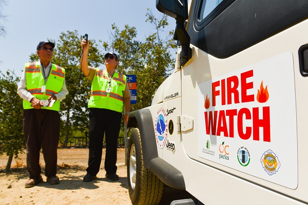 2 Fire Watch volunteers next to a truck