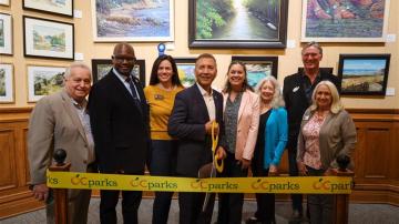 Officials cut the ribbon to open Omnivision: Art Across Boundaries now on display at the Old Orange County Courthouse