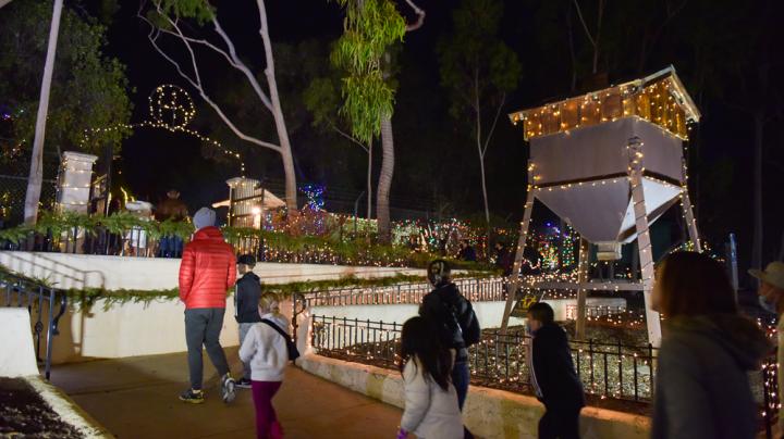 Group walks into Heritage Hill Historical Park as part of Holiday Lights. 