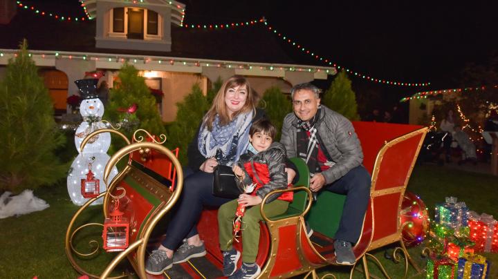 Family on a sleigh at Holiday Lights