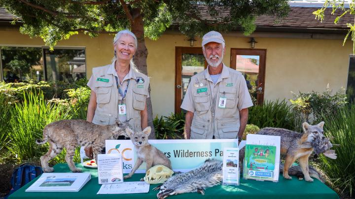 Two Caspers Park volunteers at an info night booth