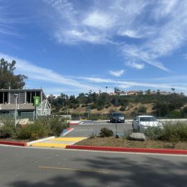 Boathouse next to parked cars in a parking lot. 