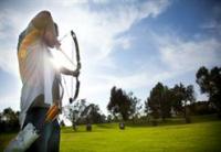 A man practices archery at the park's archery range